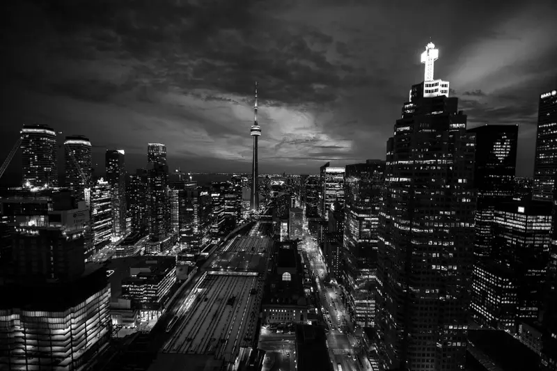 The Toronto skyline at night seen from above, with the CN Tower among lit office towers